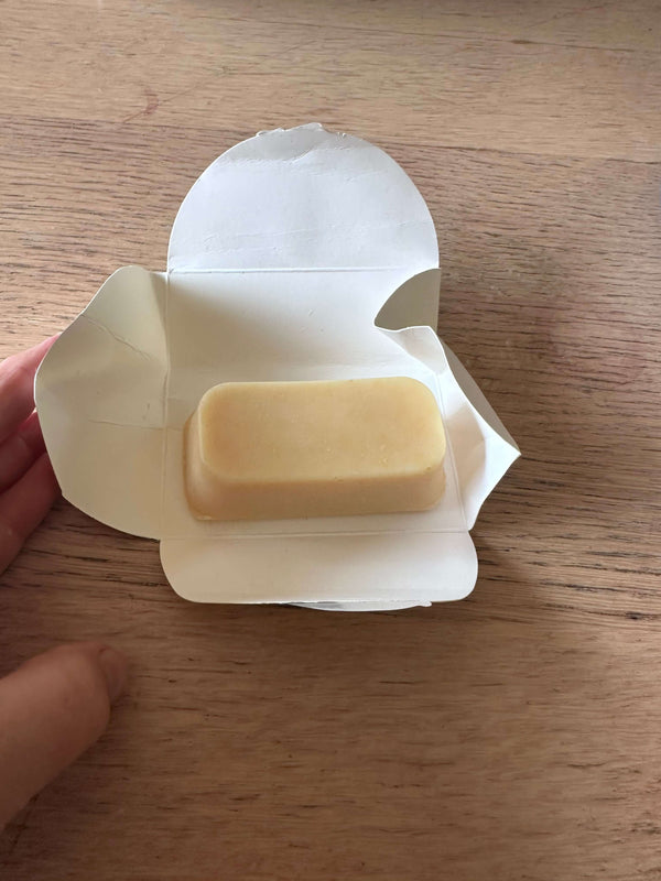 Milk Kefir Soap for sensitive skin in an open packaging on a rustic table..